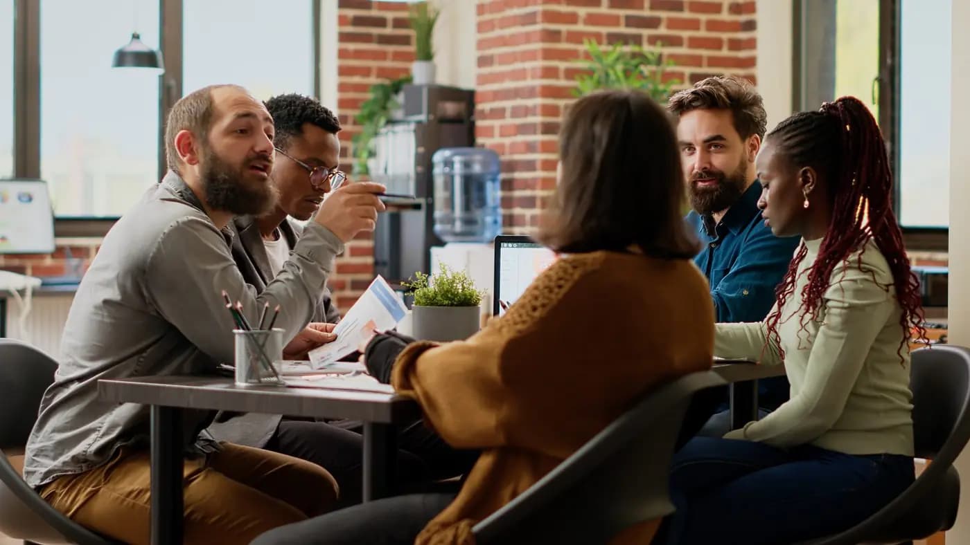 A diverse team of colleagues planning a project together in a boardroom